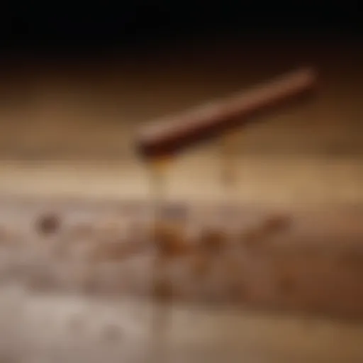 Close-up of cinnamon oil droplets on a wooden surface