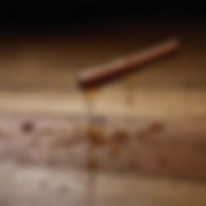 Close-up of cinnamon oil droplets on a wooden surface