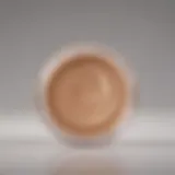 The elegant texture of a light liquid foundation swatched on a smooth surface