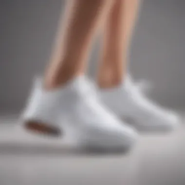 Close-up view of the cushioning and arch support in a pair of white sneakers