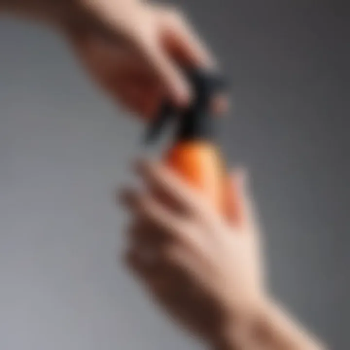 Close-up of a hand applying heat protection spray to hair.