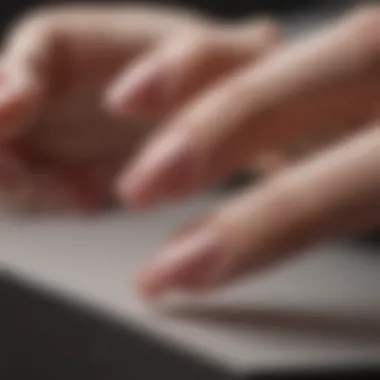 Close-up of gel nail polish being gently lifted off nails