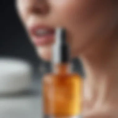 A close-up of a glass dropper releasing a powerful anti-aging serum